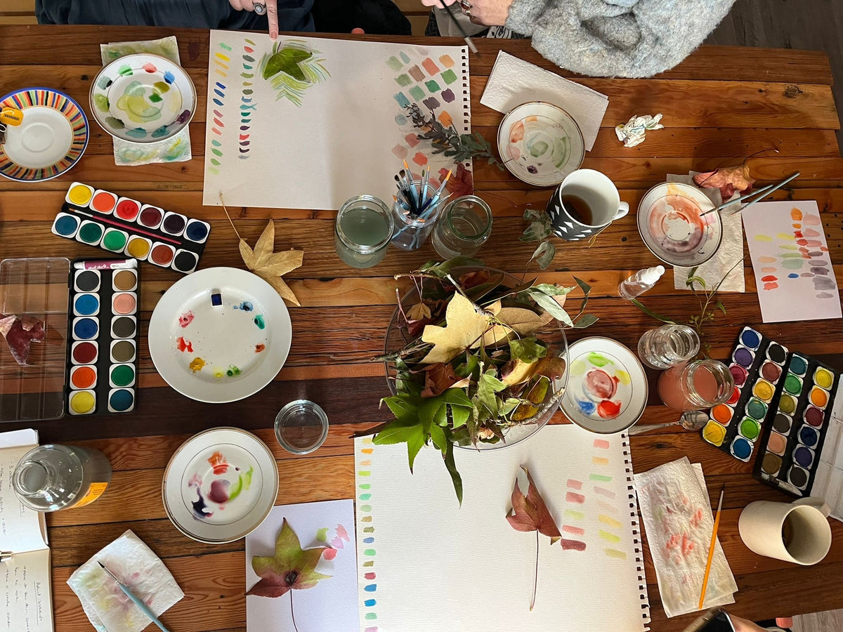 Beginner-friendly cosy watercolour workshop in Wentworthville Sydney with adults and kids painting leaves, flowers, and natural objects while enjoying tea in a relaxed creative studio.
